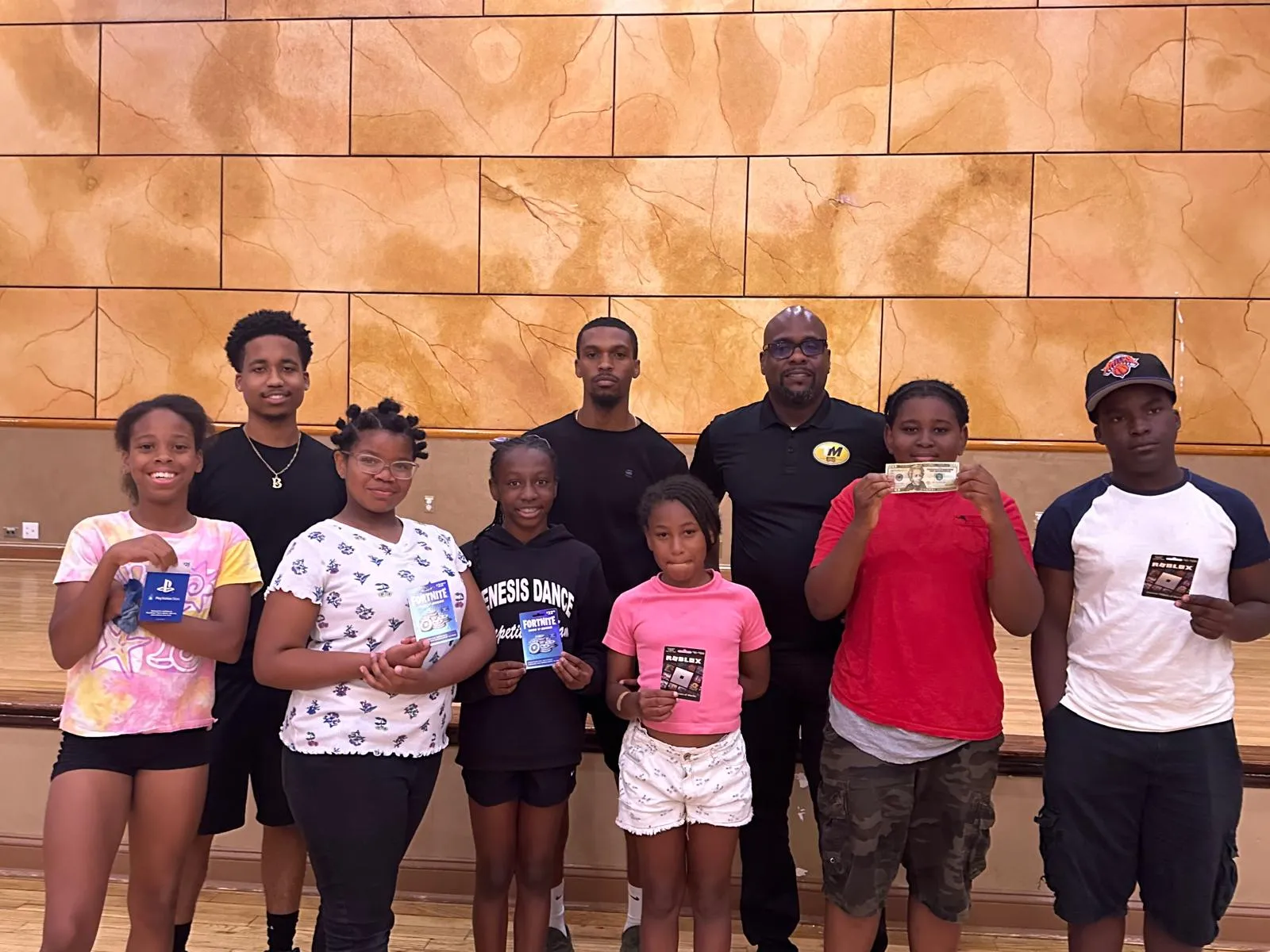 Families and community members posing together at an indoor gathering